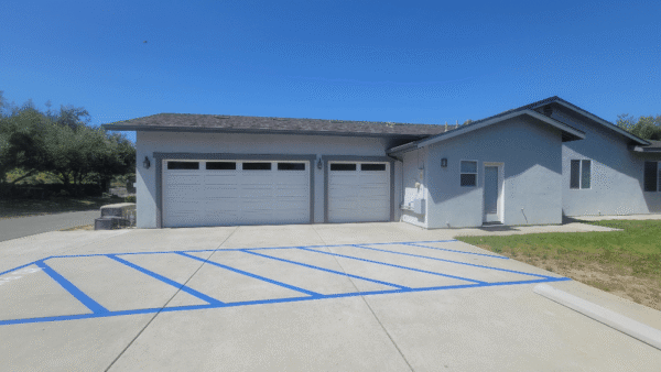 Outside of the Facility with Disabled Parking Marks and 3 car garage